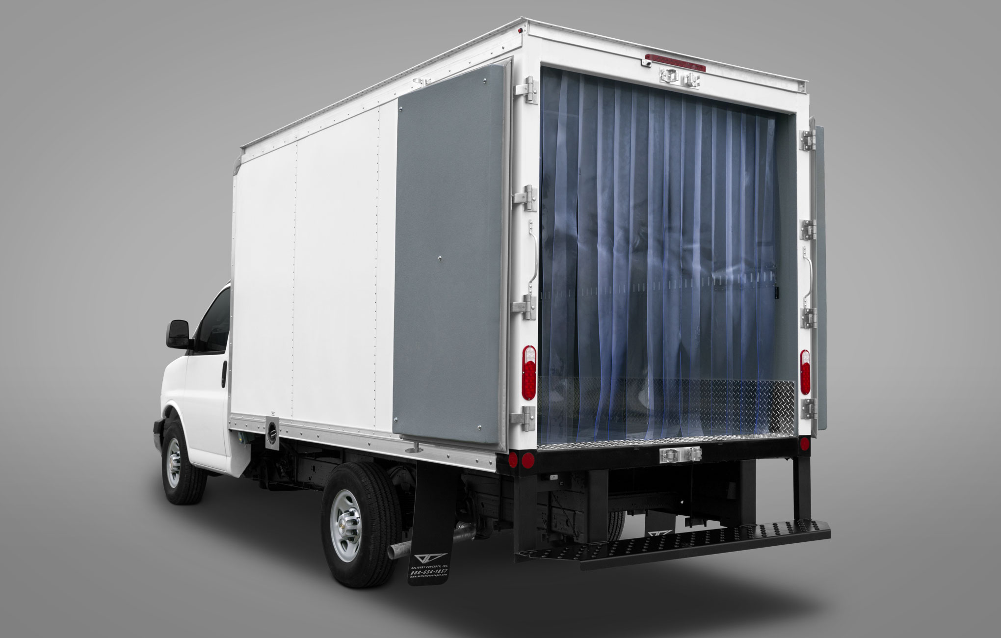 Rear 3/4 angle of refrigerated box truck with back doors open to see the inside and refrigerator curtains.