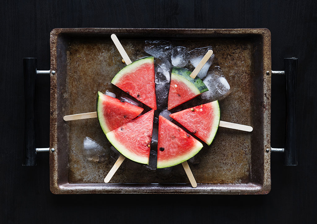 summer watermelon popsicle sticks on a tray with ice cubes