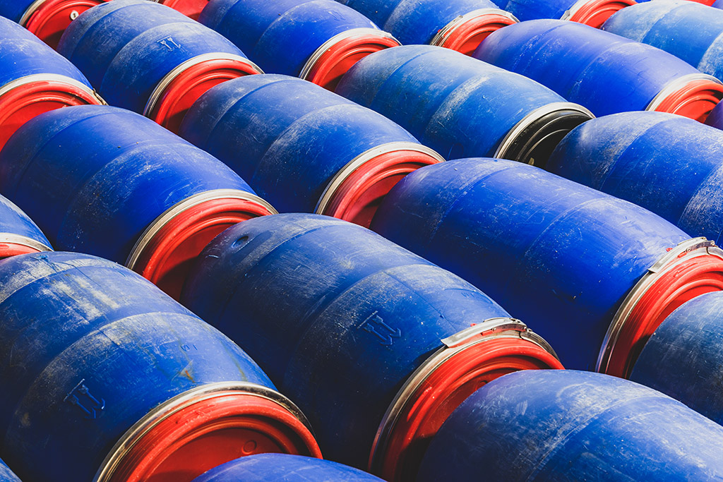 A closeup shot of blue chemical barrels in the factory