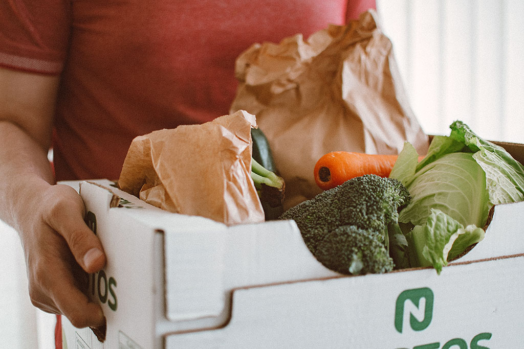 close up photo of a box full of vegetables being held by a person
