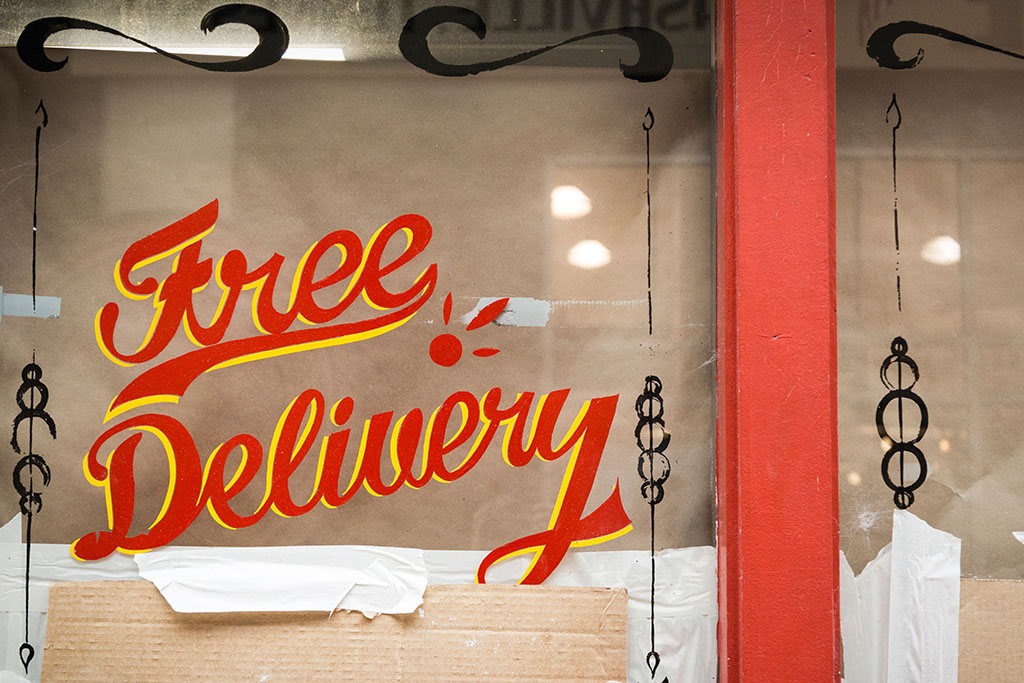 "free delivery" written on a store window